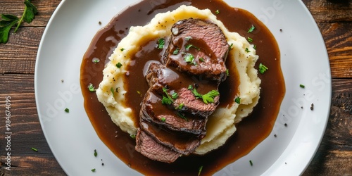 Indulge in a succulent roast beef dish, generously topped with a rich and flavorful demi glace gravy, all served alongside creamy mashed potatoes, creating a hearty and satisfying meal experience photo