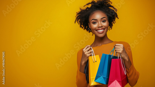 A waist-up portrait of a beautiful woman smiling joyfully, holding stylish shopping bags in both hands. The background is a vibrant, trendy colour. Aesthetically pleasing. Space for text, advertising