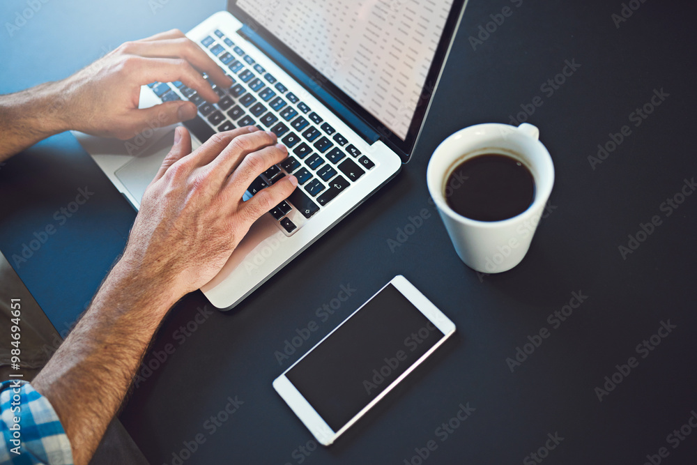 Laptop, hands and person typing for UX, online project development or research with website design. SEO designer, social media traffic and above man working on company search engine with coffee Laptop, hands and person typing for UX, online project development or research with website design. SEO designer, social media traffic and above man working on company search engine with coffee