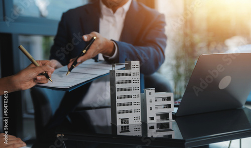 Real estate agent and customer signing contract to buy house, insurance or loan real estate.rent a house,get insurance or loan real estate or property.