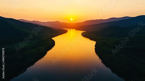 Hazy sunset over a calm river, humid weather, golden hour light