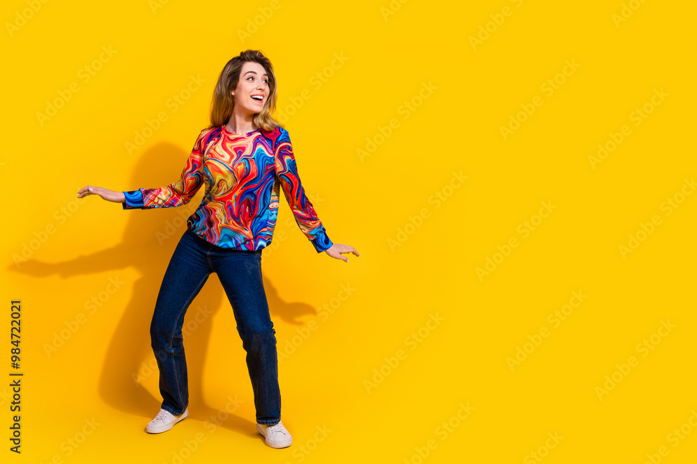 Photo portrait of young funny blonde hair adorable woman wearing bright shirt and dancing isolated on yellow color background Photo portrait of young funny blonde hair adorable woman wearing bright shirt and dancing isolated on yellow color background