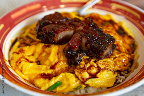 BBQ Pork Scramble Egg HK Style, Delicious Char Siu Pork Over Fluffy Omelette and Steamed Rice in Red Bowl, Mouthwatering Hong Kong Cuisine photo