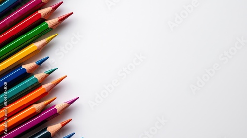 Colorful pencils arranged on a white background, perfect for art and creativity.