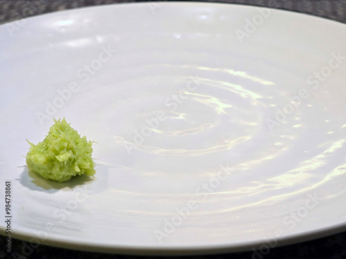 Small Wasabi paste on white plate ready for sashimi