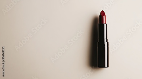 A sleek, elegant lipstick tube lying on a smooth, neutral backdrop, with plenty of negative space for text or logos, perfect for beauty-related advertisements.