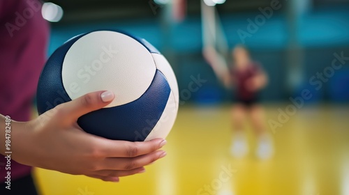 Close-up of a hand holding a volleyball photo