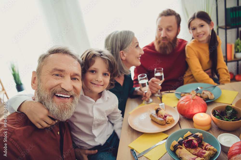 Photo of smiling happy people relatives celebrating thanksgiving day family gathering indoors room home Photo of smiling happy people relatives celebrating thanksgiving day family gathering indoors room home
