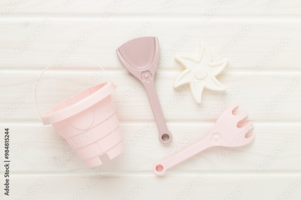 Cute toys for playing with sand on wooden background, top view Cute toys for playing with sand on wooden background, top view