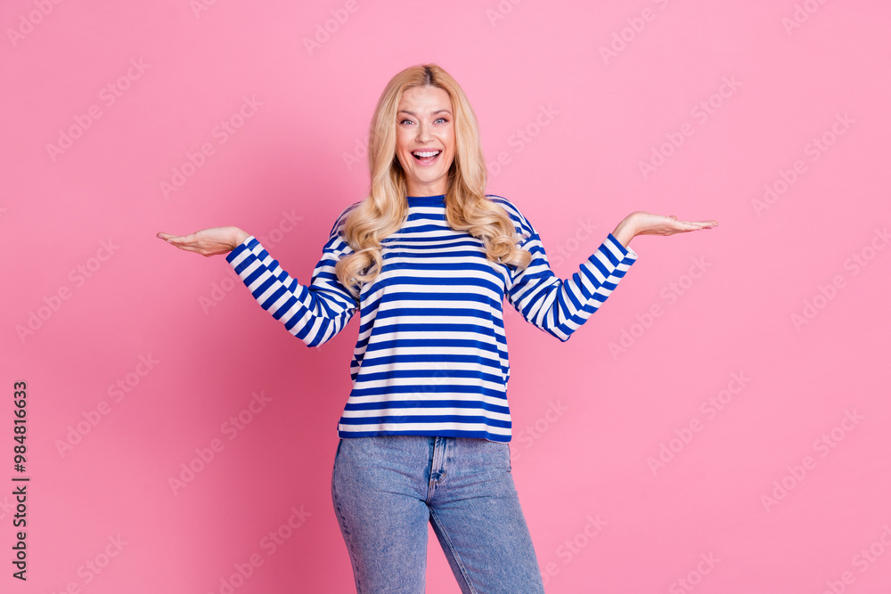 Photo of lovely cute woman wear stylish sweatshirt demonstrate empty space isolated on pink color background Photo of lovely cute woman wear stylish sweatshirt demonstrate empty space isolated on pink color background