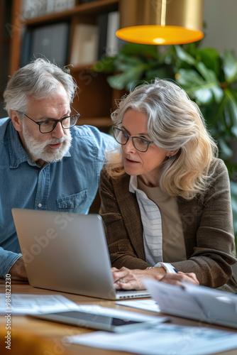  Business professionals, a woman and man, engaged in a detailed project discussion at a cafe 