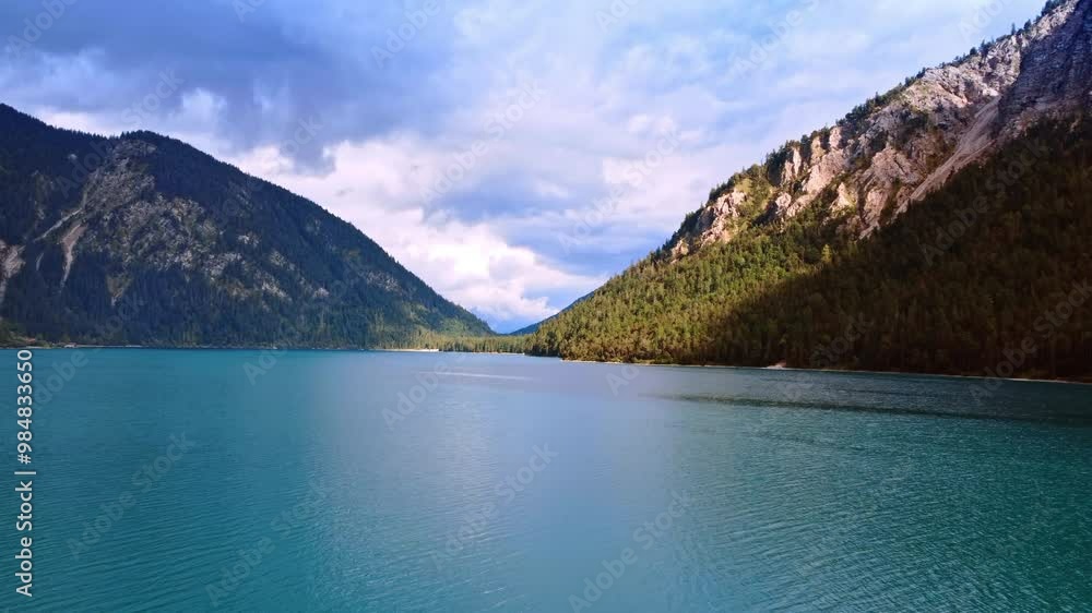 Calm beautiful cityscape of blue lake surrounded by high mountains. Waterscape in Lichtenstein in wild nature. Calm beautiful cityscape of blue lake surrounded by high mountains. Waterscape in Lichtenstein in wild nature.