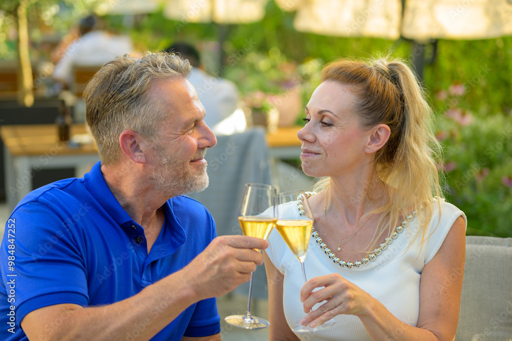 Couple Sharing a Romantic Toast with Champagne Outdoors Couple Sharing a Romantic Toast with Champagne Outdoors