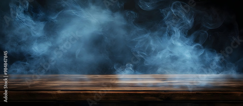 A dark background enhances the visual appeal of an empty wooden table with smoke rising creating an atmospheric and artistic copy space image