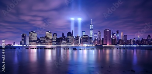 Night skyline view with glowing blue and purple lights, mall lights illuminating the scene in long exposure photography style.