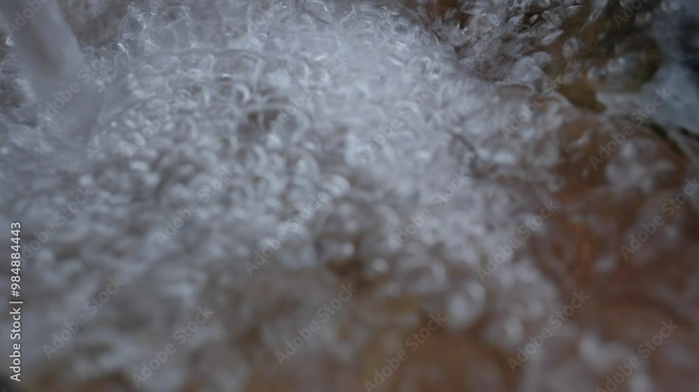 water bubbling from a waterfall falling on a stone close up, slow motion
water bubbling from a waterfall falling on a stone close up, slow motion