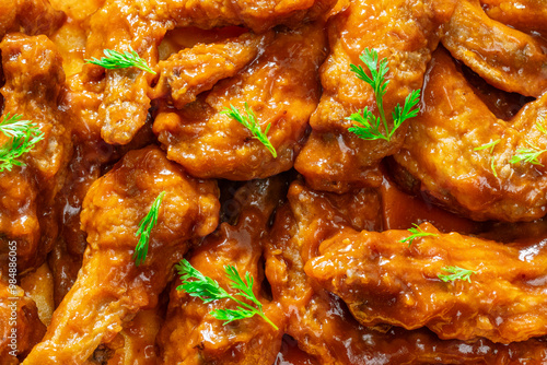 chicken wings smothered in hot sauce, close-up view