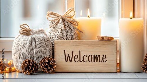 A wooden welcome sign greets guests near a beautifully lit window, with candles and drinks creating a warm, inviting atmosphere for a festive evening photo