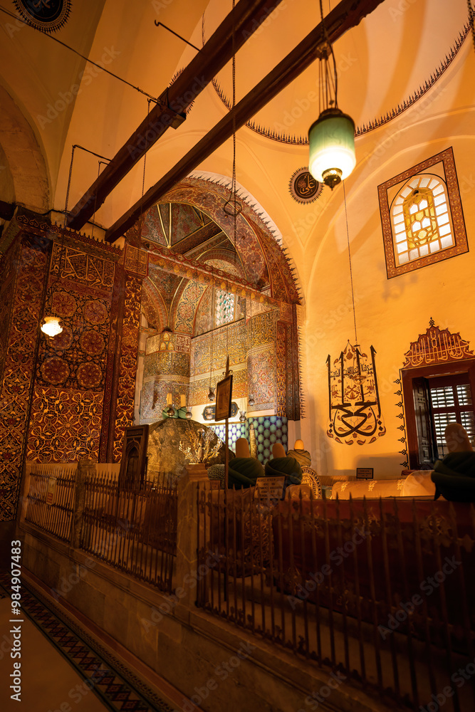 Konya, Turkey: The serene interior of a mosque in Konya, Turkey, featuring intricate tilework, calligraphy, and a peaceful atmosphere.