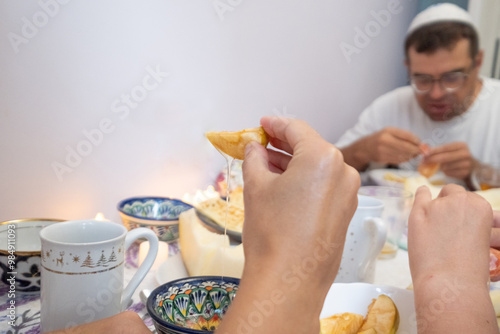 family, eating, food, meal, mother, child, woman, dinner, together, people, smiling, home, daughter, table, father, breakfast, children, boy, parent, kitchen, indoors, sitting, african american, hispa photo