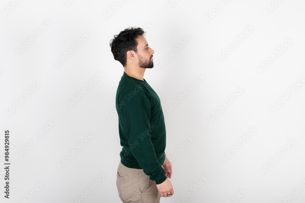 Portrait of a young latin man in profile on white background