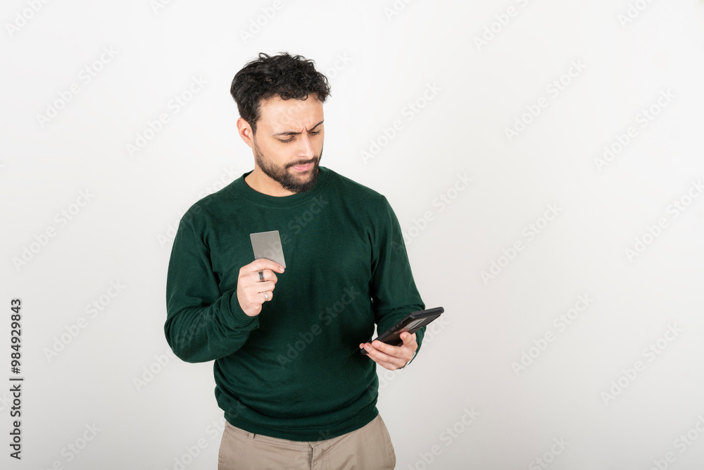 Young man making an online purchase with a credit card Young man making an online purchase with a credit card