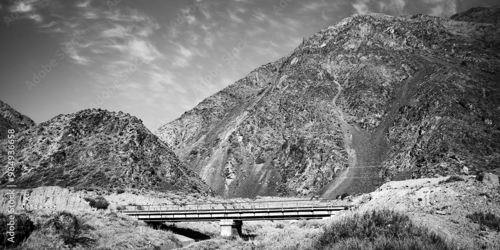 Dramatic panoramic black and white landscape with a mountain in the steppe