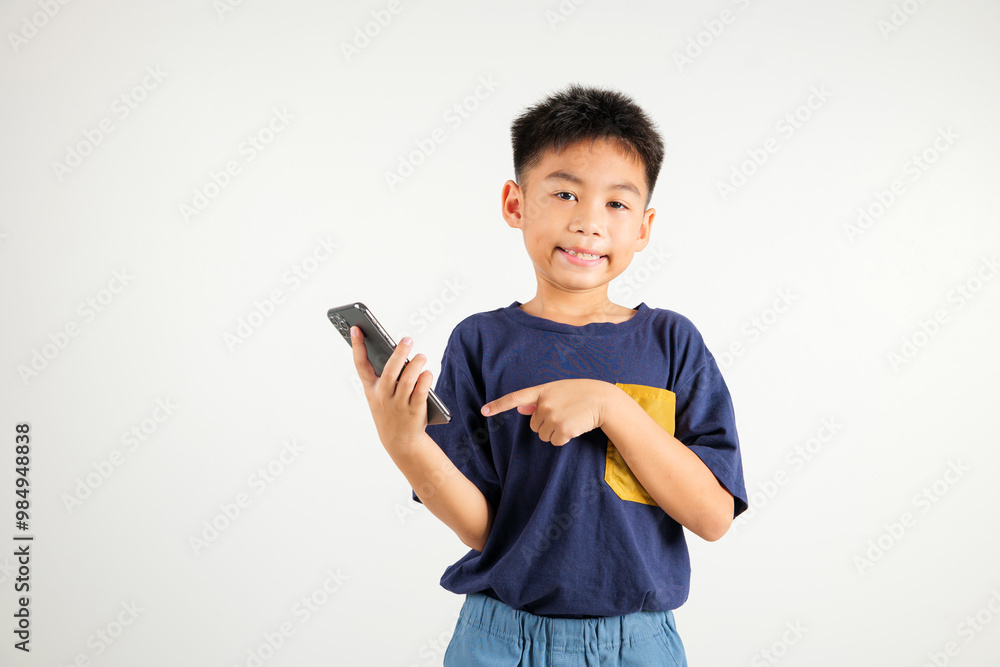 Portrait Asian happy young kid boy smile making finger pointing on screen smartphone in hand, Primary children attractive shopping online application isolated studio shot white background Portrait Asian happy young kid boy smile making finger pointing on screen smartphone in hand, Primary children attractive shopping online application isolated studio shot white background