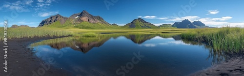 A Tranquil Reflection of Mountain Peaks and Sky in a Still Water