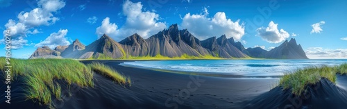 Majestic Mountain Range Overlooking Black Sand Beach and Turquoise Ocean photo