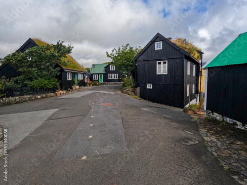 Beautiful architectural and nature views in the Old Town District in Tórshavn, the capital city of the Faroe Islands. Natural grass rooftops set against a cloudy blue sky. Streymoy, Faeroe Islands.