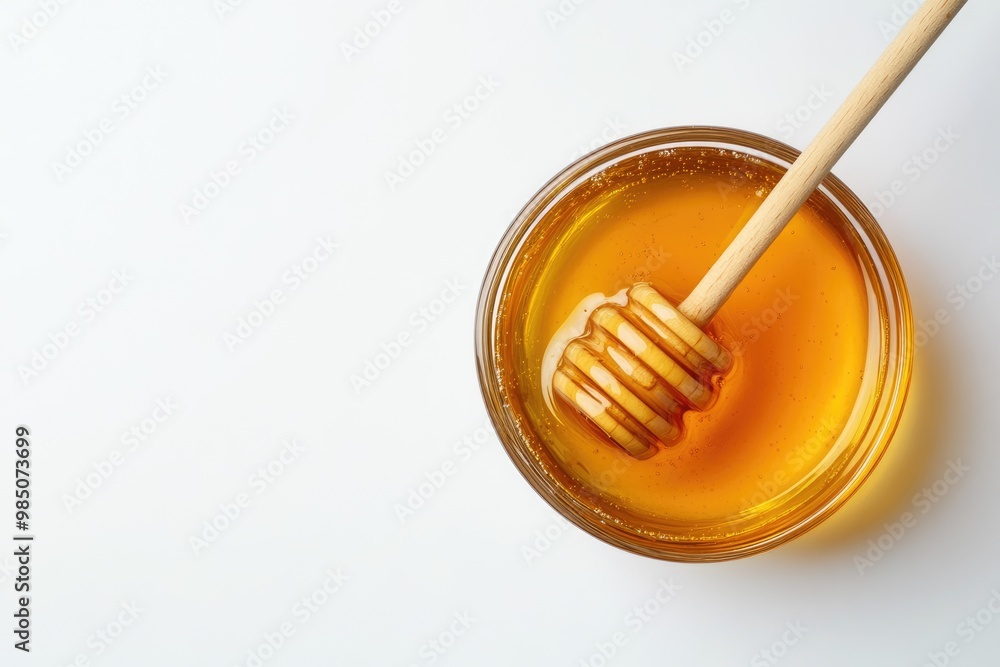 Flat lay glass bowl of honey with dipper on white background. Flat lay glass bowl of honey with dipper on white background.