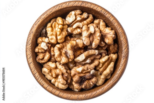 Close up walnut kernel halves in wooden bowl for snacking or baking.