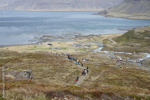 Isafjordur, Iceland - tourists hiking and walking around at Dynjandi, Fjallfoss cascading waterfall sightseeing location Dynjandisá floating into fjords photo