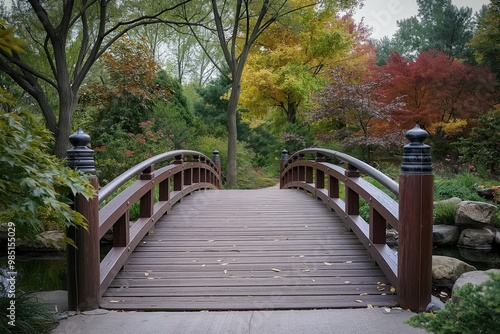 Wooden bridge in serene Japanese garden with natural scenery. Wooden bridge over small creek with flowing water and lush plants. Anderson Japanese Garden iconic landmark.