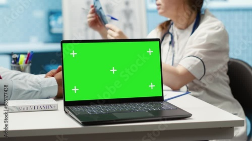 Wallpaper Mural General practitioner and patient looking at green screen on device, recommending pills and drugs during check up visit. Diverse people discussing about diagnostics and remedy. Camera A. Torontodigital.ca