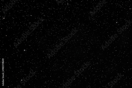 Black night sky filled with tiny shining stars, bright glow. Sparkling celestial bodies in dark space. Beautiful starry galaxy with shining starlight. Glistering background for fantasy wallpapers,