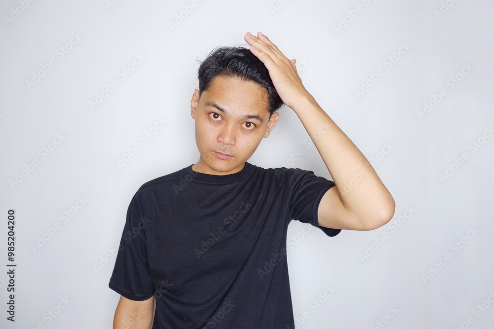 portrait of a handsome Indonesian man posing randomly wearing a black shirt on a white background isolated portrait of a handsome Indonesian man posing randomly wearing a black shirt on a white background isolated