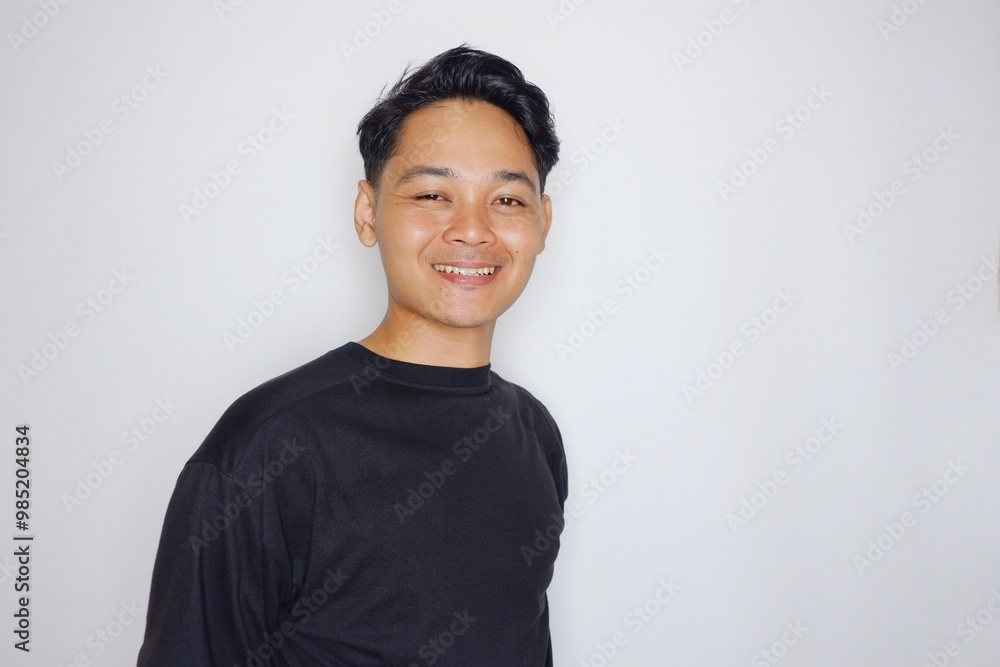 portrait of a handsome Indonesian man posing randomly wearing a black shirt on a white background isolated portrait of a handsome Indonesian man posing randomly wearing a black shirt on a white background isolated