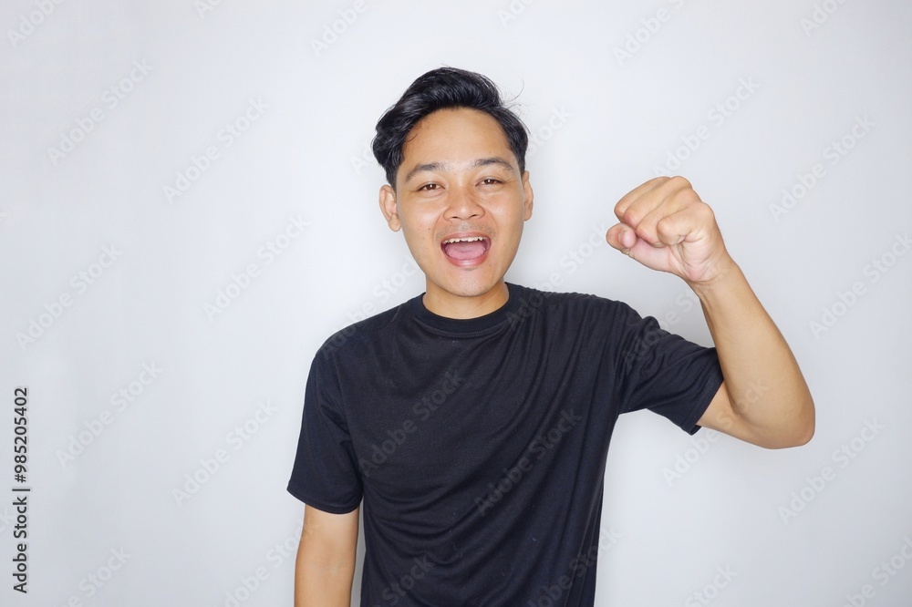 portrait of a handsome Indonesian man posing randomly wearing a black shirt on a white background isolated portrait of a handsome Indonesian man posing randomly wearing a black shirt on a white background isolated