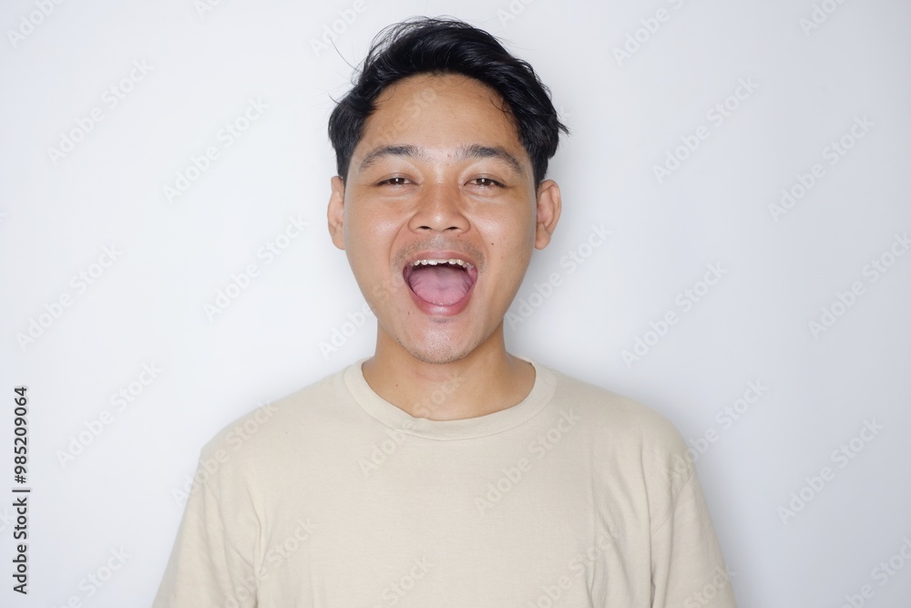 portrait of a handsome Indonesian man posing randomly wearing a Cream shirt on a white background isolated portrait of a handsome Indonesian man posing randomly wearing a Cream shirt on a white background isolated