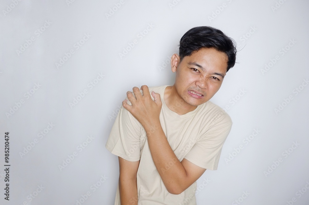 portrait of a handsome Indonesian man posing randomly wearing a Cream shirt on a white background isolated portrait of a handsome Indonesian man posing randomly wearing a Cream shirt on a white background isolated