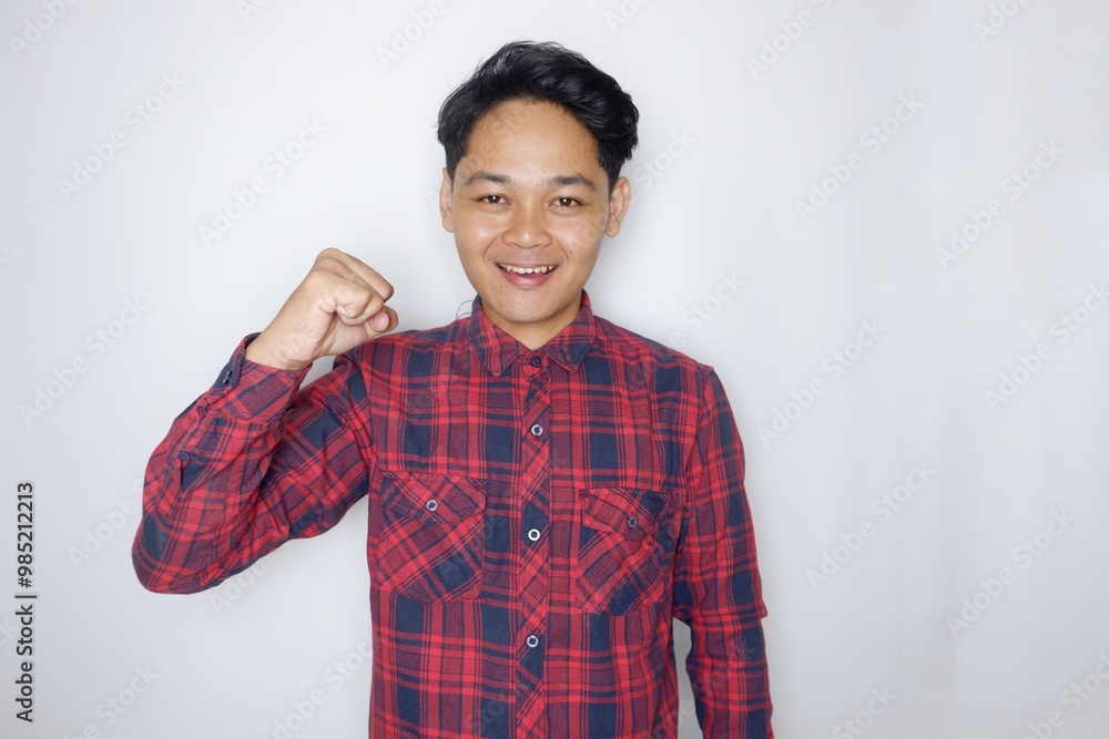 portrait of a handsome Indonesian man having a random expression wearing a checkered red flannel shirt on a white isolated background portrait of a handsome Indonesian man having a random expression wearing a checkered red flannel shirt on a white isolated background
