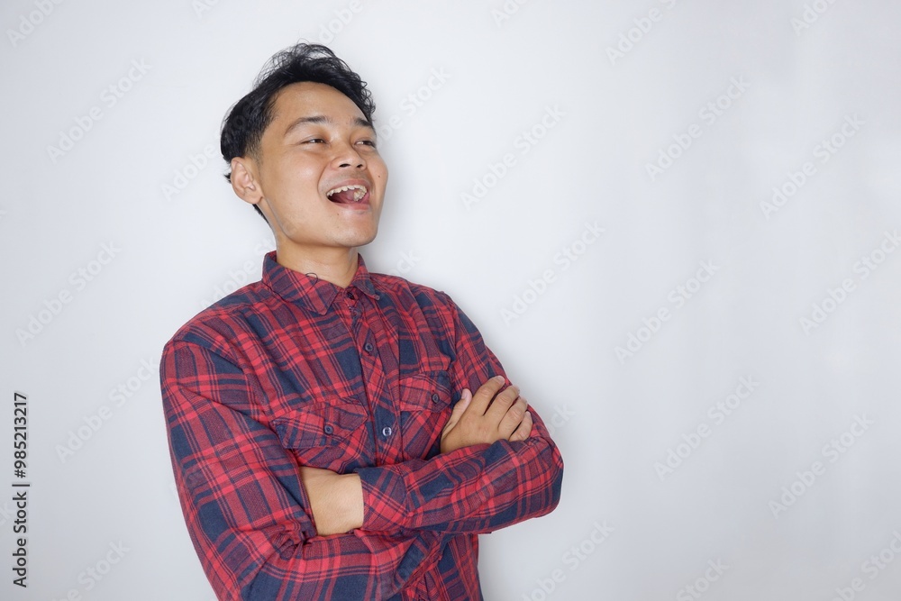portrait of a handsome Indonesian man having a random expression wearing a checkered red flannel shirt on a white isolated background portrait of a handsome Indonesian man having a random expression wearing a checkered red flannel shirt on a white isolated background