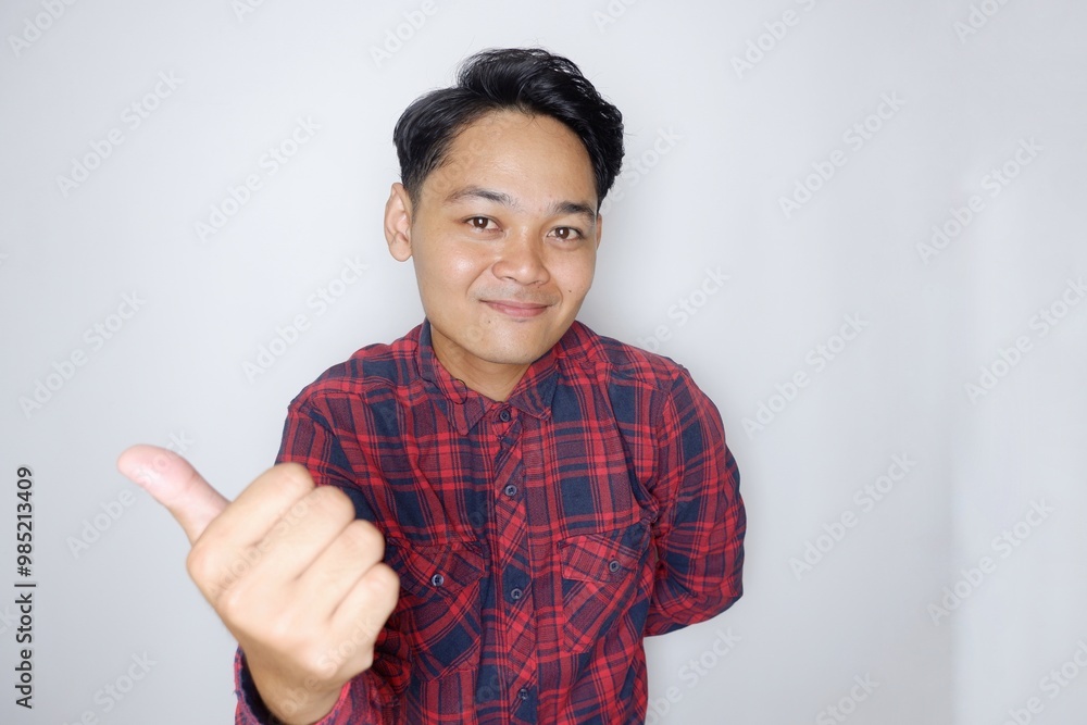 portrait of a handsome Indonesian man having a random expression wearing a checkered red flannel shirt on a white isolated background portrait of a handsome Indonesian man having a random expression wearing a checkered red flannel shirt on a white isolated background