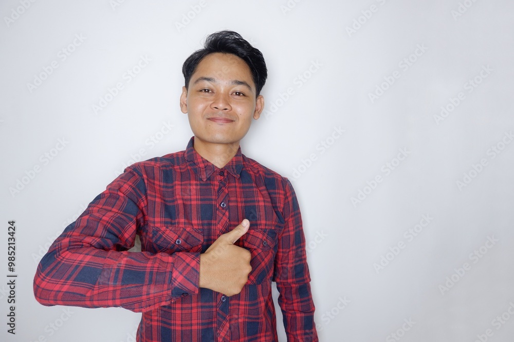 portrait of a handsome Indonesian man having a random expression wearing a checkered red flannel shirt on a white isolated background portrait of a handsome Indonesian man having a random expression wearing a checkered red flannel shirt on a white isolated background