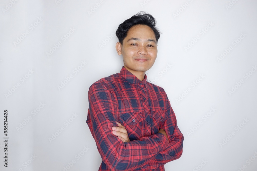 portrait of a handsome Indonesian man having a random expression wearing a checkered red flannel shirt on a white isolated background portrait of a handsome Indonesian man having a random expression wearing a checkered red flannel shirt on a white isolated background