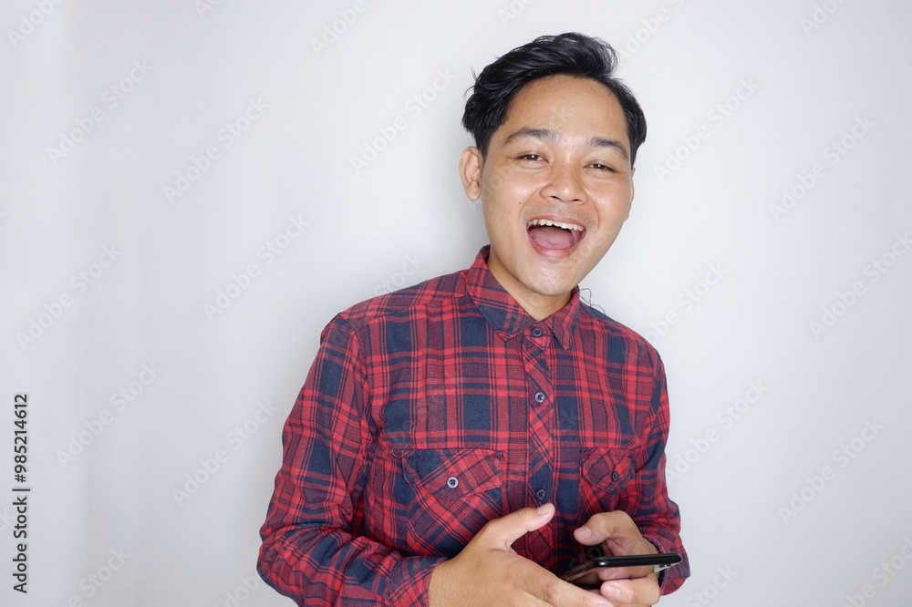 portrait of a handsome Indonesian man having a random expression wearing a checkered red flannel shirt on a white isolated background portrait of a handsome Indonesian man having a random expression wearing a checkered red flannel shirt on a white isolated background