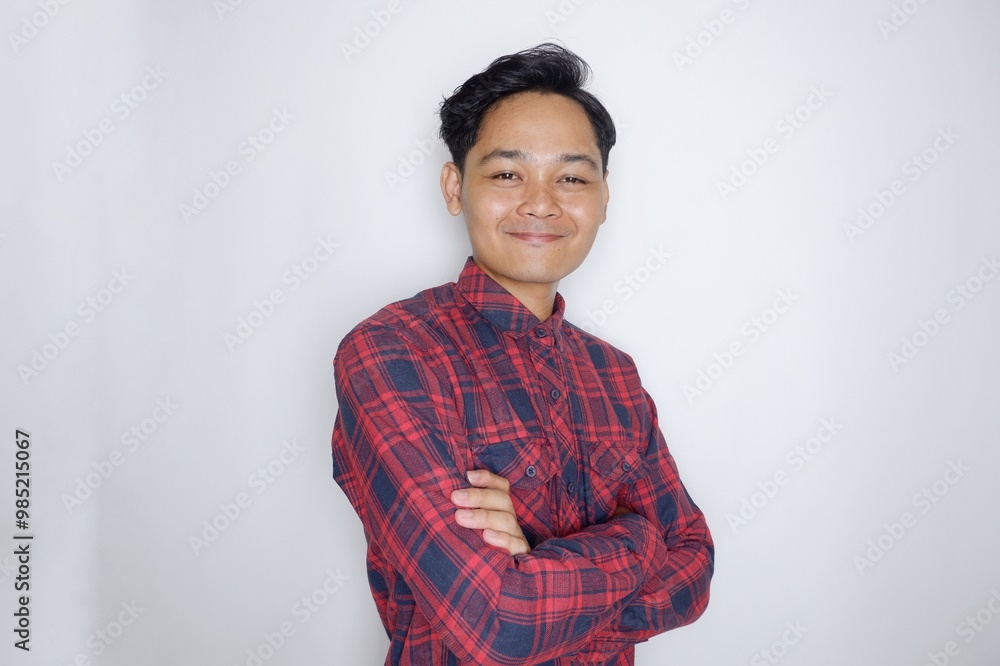 portrait of a handsome Indonesian man having a random expression wearing a checkered red flannel shirt on a white isolated background portrait of a handsome Indonesian man having a random expression wearing a checkered red flannel shirt on a white isolated background