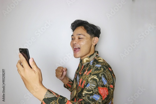 Handsome Indonesian man wearing batik with various expressions isolated white background photo